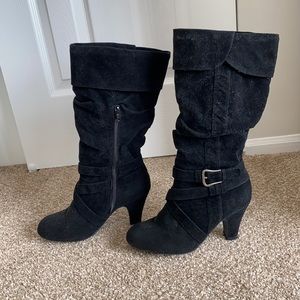 Black boots with buckle detail and zipper opening